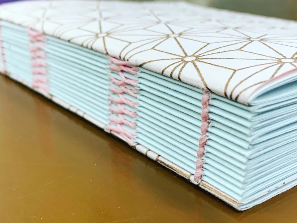 Read more about the article French link open spine books 21-23. Circling back for a bit of sewing.